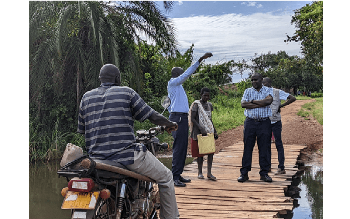 Engineer Andrew Olal interacting with a farmer in Agago District.